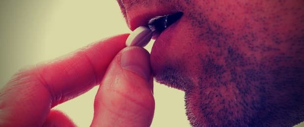 man taking prescription pill