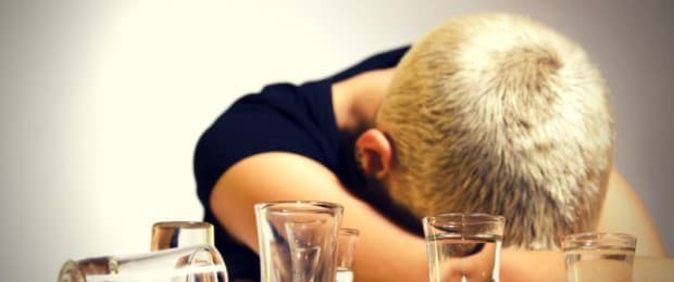 woman with head down drinking alcohol