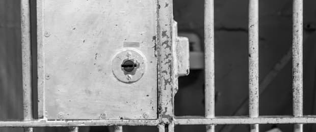person in prison cell
